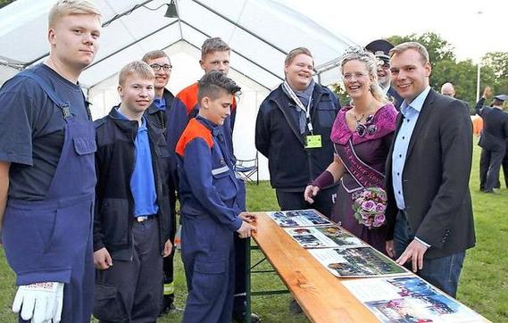 Die Ehrengäste begutachten während des Kreisjugendlagers eine Fotodokumentation der Jugendfeuerwehr aus Spremberg.